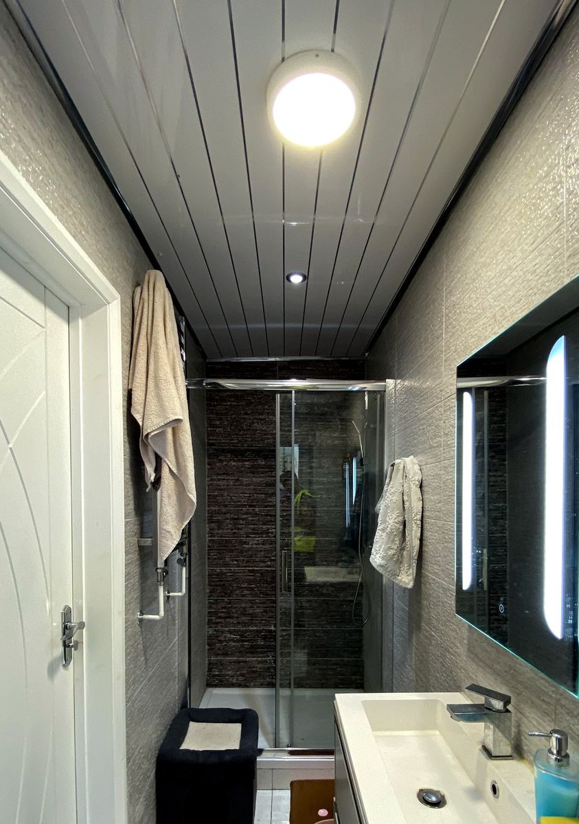En-suite renovation with dark stone-effect tiling and walk-in shower