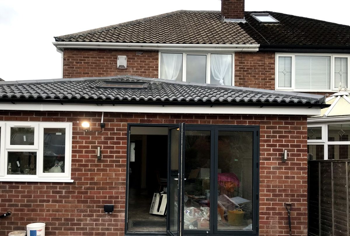 Rear extension with anthracite bi-fold doors, brick-matched to the existing house, Manchester