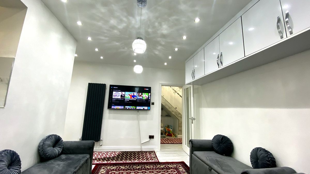 Open-plan living space renovation with built-in gloss storage