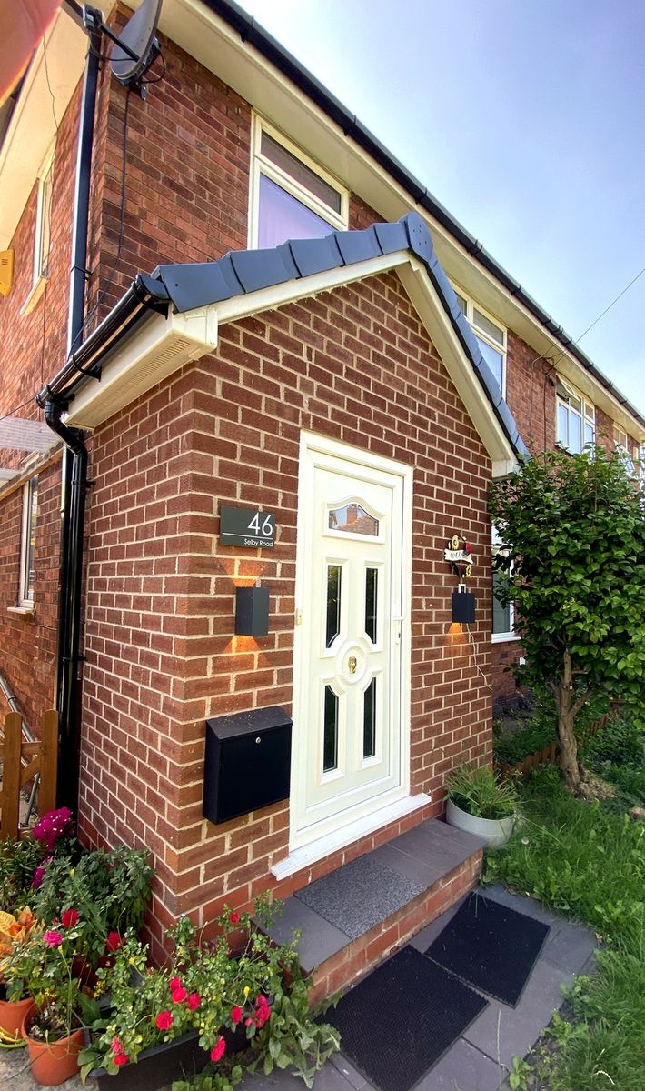 Finished front porch, brick-matched with white uPVC door and canopy