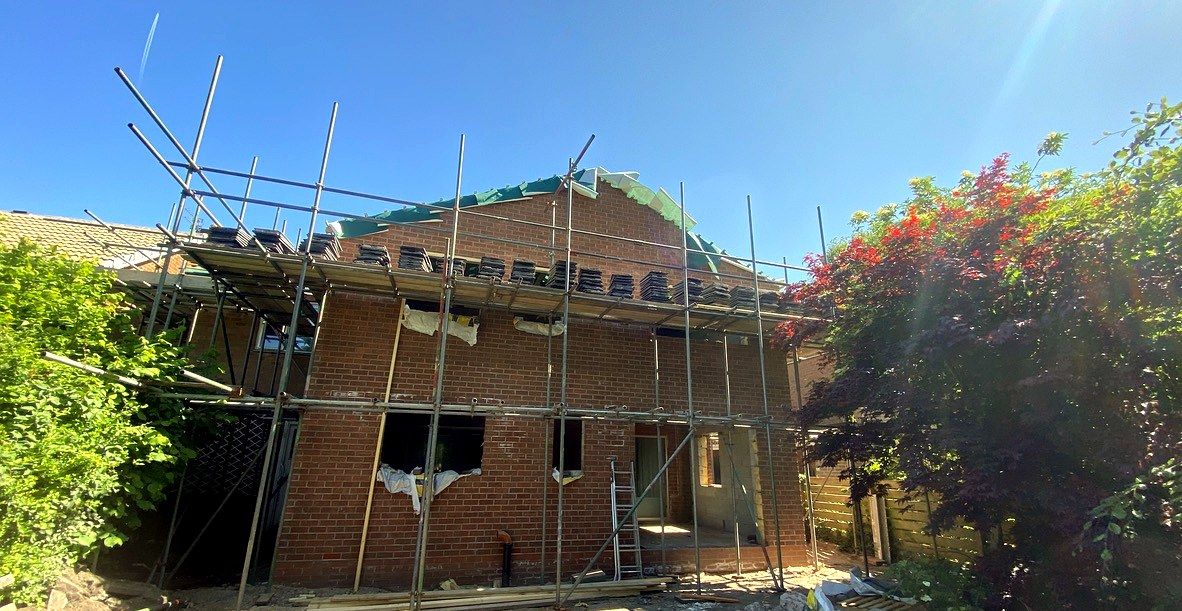 Extension mid-build, scaffold up and roof tiling underway